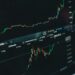 Bitcoin value charts displayed on a digital screen with financial data and graphs.