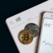 Digital tokens on a screen with financial graphs, representing Trump's new venture for shareholders.