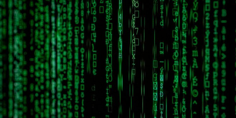 A hacker examines code with a background of social media icons, highlighting data vulnerability.