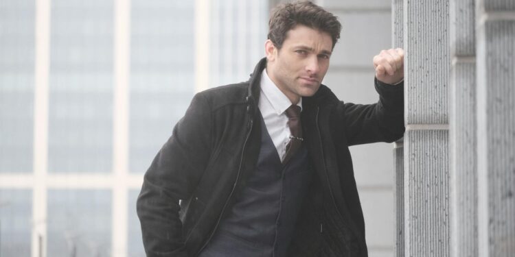 A businessman handcuffed by police outside a government building, with Bitcoin logos in the background.