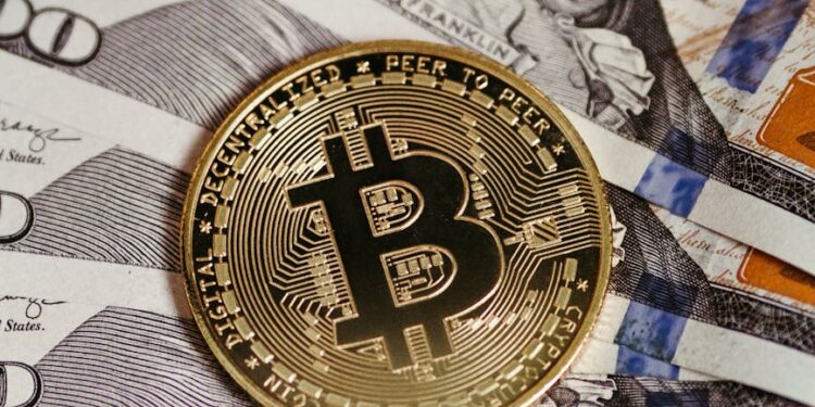 Bitcoin coins stacked with a financial graph and dollar bills in the background.