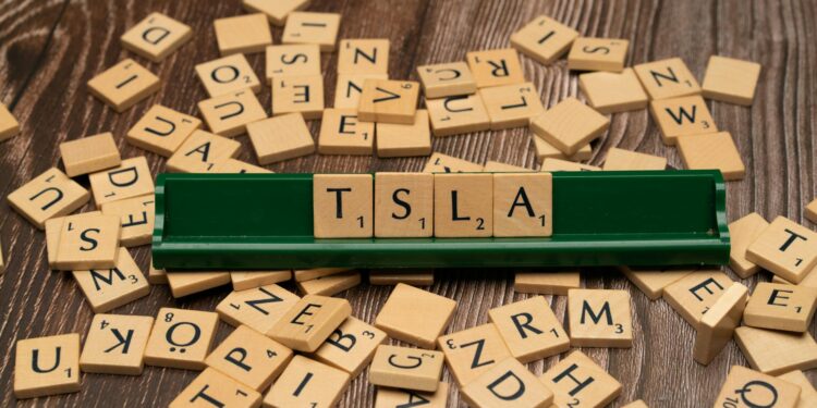 Stock market ticker display showing Nasdaq logo with downward trend graphics and crypto symbols.