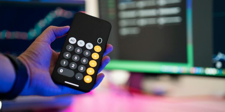 A person analyzing cryptocurrency charts on a computer screen with financial data.