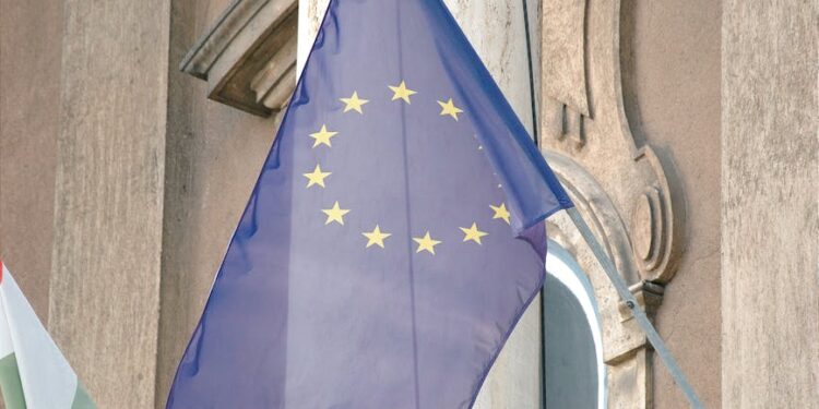 Polymarket logo with European Union and national flags of Portugal and Hungary in background.