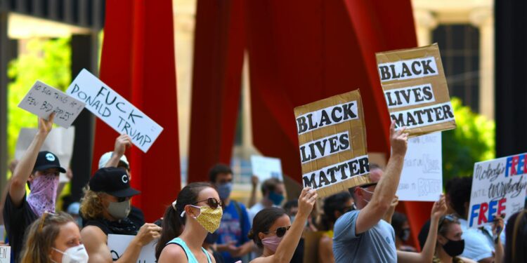 Protesters hold signs against crypto regulation outside a Manhattan courthouse.