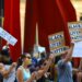 Protesters hold signs against crypto regulation outside a Manhattan courthouse.
