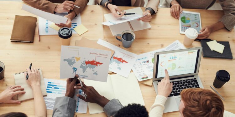 Ritchie Torres speaking at a podium with graphs and charts about prediction markets.