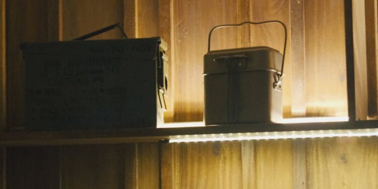 A military equipment display with cryptocurrency symbols in the background.