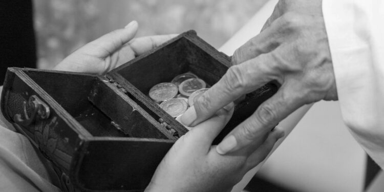 Crypto coins and cash stacked around a Trump campaign donation box.