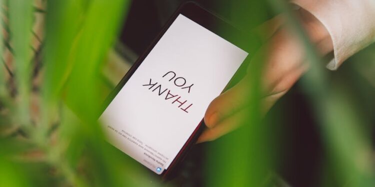 Close-up of a smartphone displaying a phishing message about cryptocurrency scams.