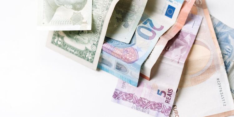 Chinese yuan banknotes with a declining dollar symbol in the background, representing finance trends.