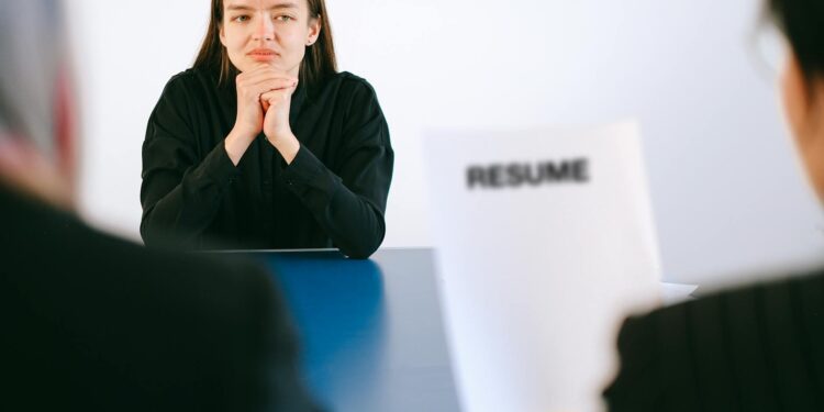 Job seekers in an office environment reviewing employment opportunities and trends.