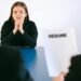 Job seekers in an office environment reviewing employment opportunities and trends.