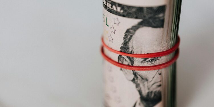 Bitcoin symbol with rising graphs and US dollar bills representing national debt growth.