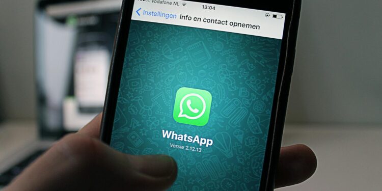 A smartphone displaying the WhatsApp logo against a backdrop of legal documents.