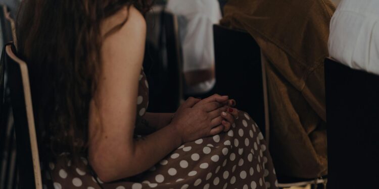 Brian Quintenz speaking at a crypto compliance conference with SUI Group logo in the background.