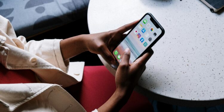 A cozy café setting with people interacting with AI companions on digital devices.