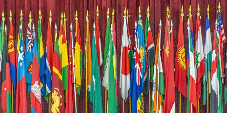 Flags of 48 countries symbolizing global cooperation on crypto transparency regulations.