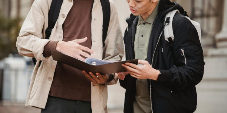 Students exchanging backpacks at a campus event, symbolizing a collaborative finance initiative.