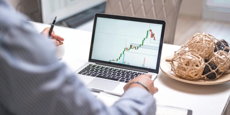 Investors analyzing cryptocurrency trends on digital screens in a modern office setting.