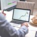 Investors analyzing cryptocurrency trends on digital screens in a modern office setting.
