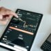 A graphic illustrating a downward trend in cryptocurrency trading on a stock market chart.
