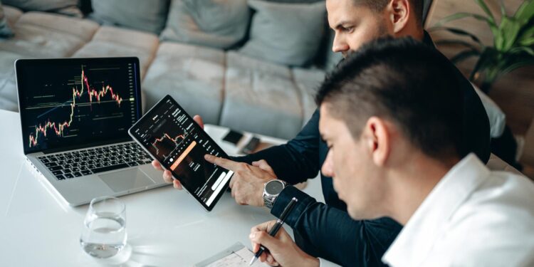 Business meeting with graphs and charts discussing OnlyFans stake sale to Architect Capital.