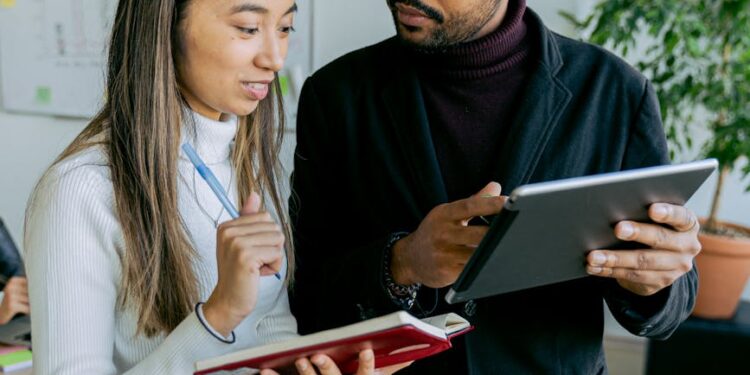 Two business professionals discussing stablecoin technology at a modern office setting.