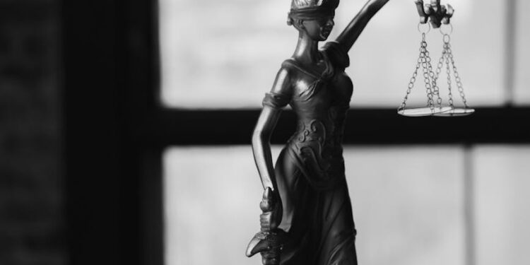 Ilya Lichtenstein smiling, surrounded by legal papers and cryptocurrency symbols.