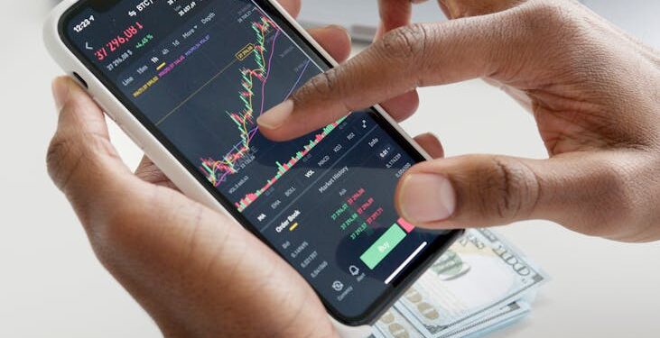 Crypto.com logo displayed on a digital screen with financial charts in the background.