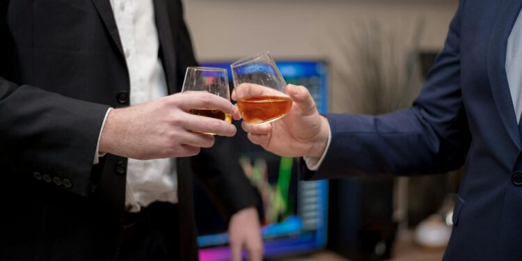 A Barclays representative shaking hands with Ubyx executives in a finance office setting.