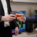 A Barclays representative shaking hands with Ubyx executives in a finance office setting.