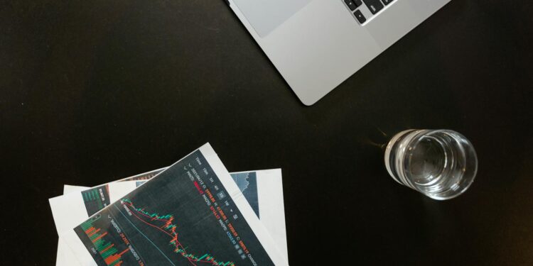 Investors analyzing charts and coins at a crypto trading desk with Patos logo in view.