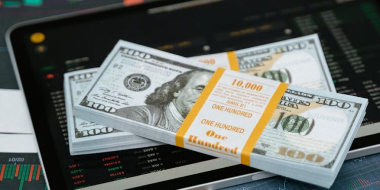 A financial analyst examines charts showing XRP price trends and ETF filings on digital screens.