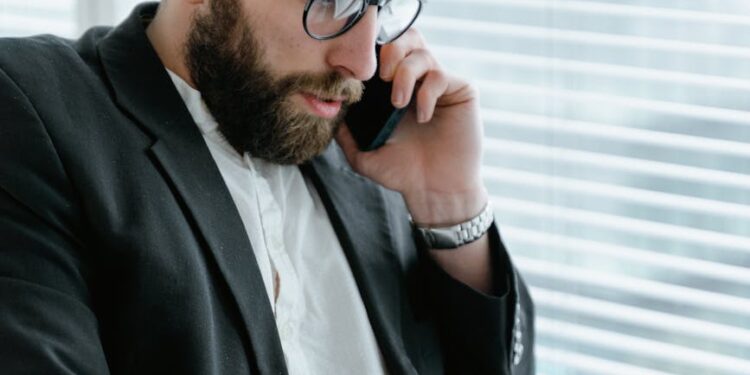 Business meeting with executives discussing acquisition plans on a digital display.