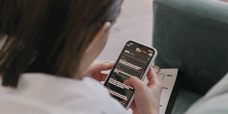 A person using a smartphone, highlighting concerns over messaging app security risks.