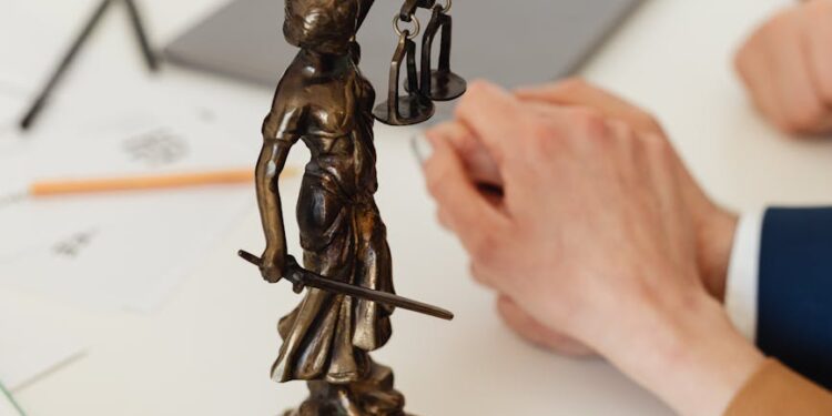 Gavel and scales of justice resting on financial documents, representing regulatory penalty actions.