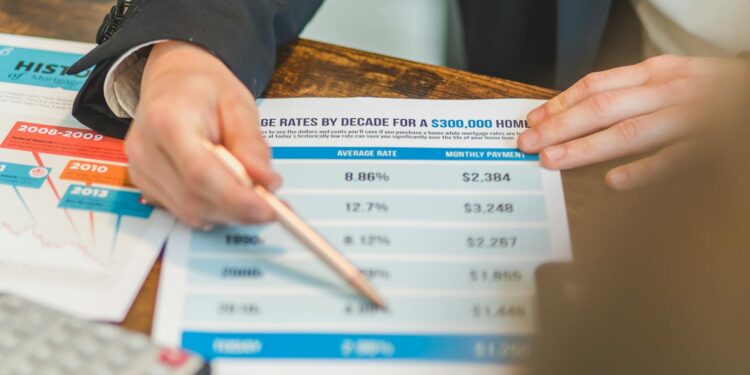 Jerome Powell speaking at a podium with charts depicting interest rates and financial regulations.