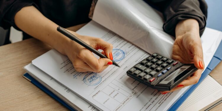 An official at a desk reviewing cryptocurrency compliance documents.