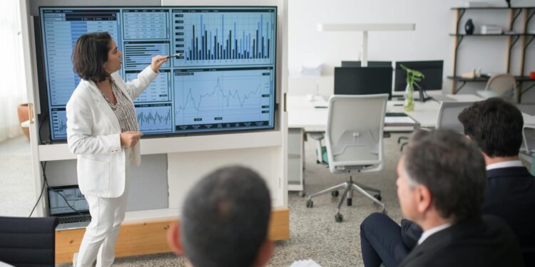 A business meeting with executives discussing cryptocurrency investments and reporting tools.