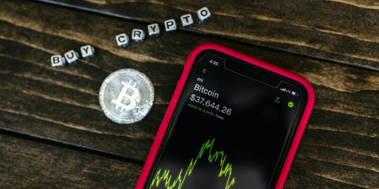 A person examines Bitcoin charts on a screen, highlighting institutional interest in crypto.