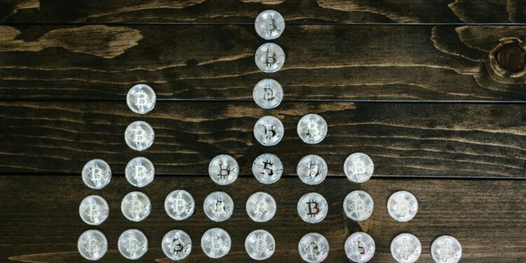 Stack of gold and silver coins with a rising graph overlay, symbolizing inflation-driven price surge.