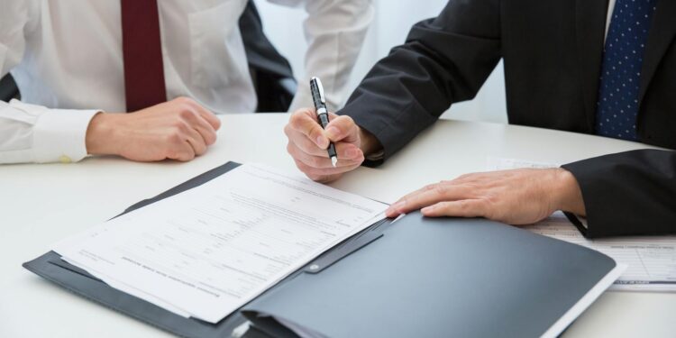 A gavel and legal documents on a table, symbolizing financial regulations in sports contracts.