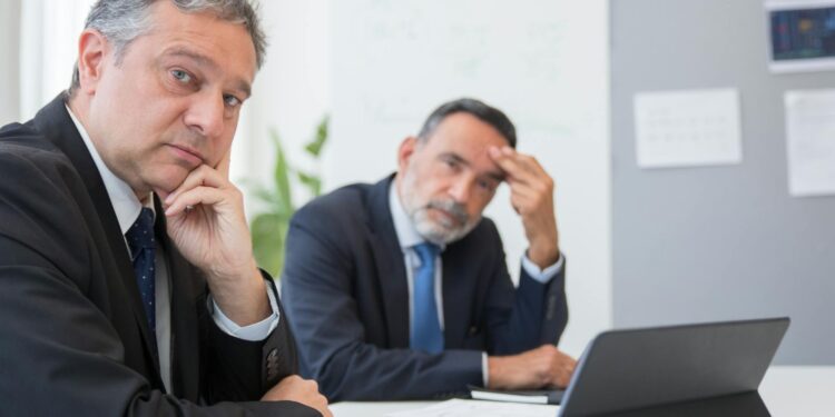 MrBeast and BitMine executives discuss investment strategy in a modern office setting.