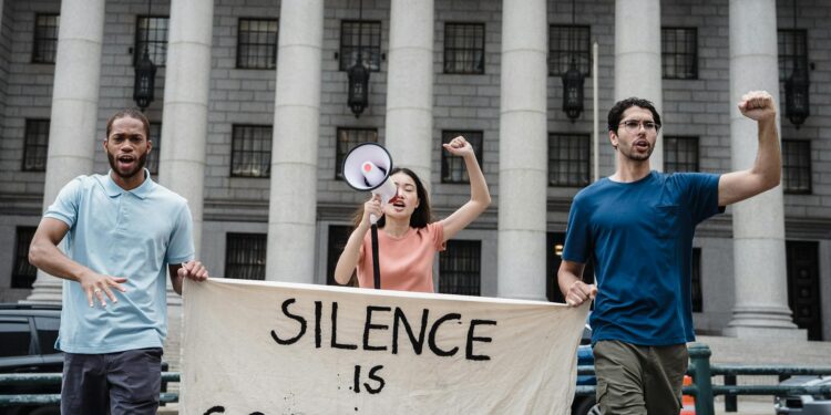 Protesters hold signs urging senators to oppose the crypto regulation bill in front of a government building.