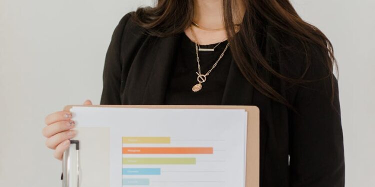 Trump gestures during a press conference, with charts and tariffs data in the background.