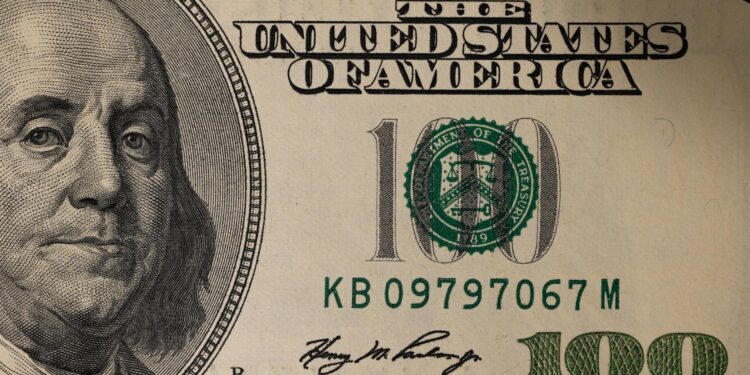 U.S. Treasury Secretary speaking at a podium, discussing Bitcoin and financial regulations.