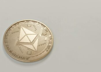Graphic depicting Ethereum logo with ETH coins and a staking symbol on a digital background.