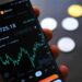 Smartphone displaying crypto trading interface with automated grid and martingale settings.