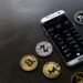A person using a smartphone to buy cryptocurrency through a banking app.
